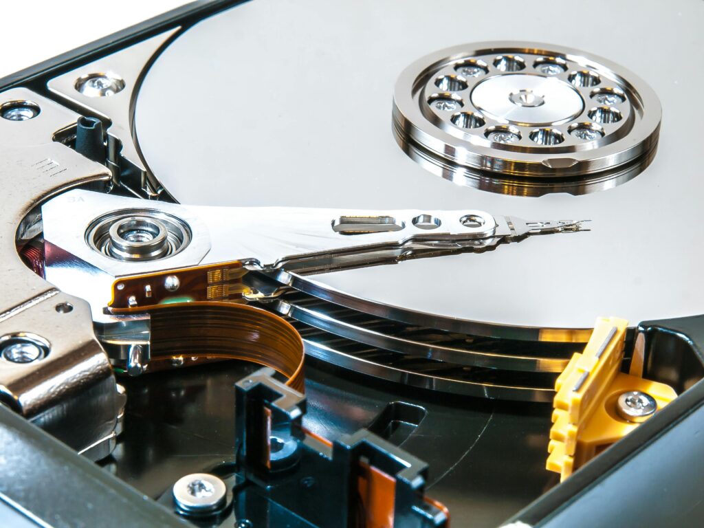 Detailed view of an open hard drive showing its internal mechanisms and disk platters.